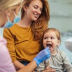Pediatric dentist in Calgary checking child’s teeth
