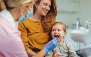 Pediatric dentist in Calgary checking child’s teeth